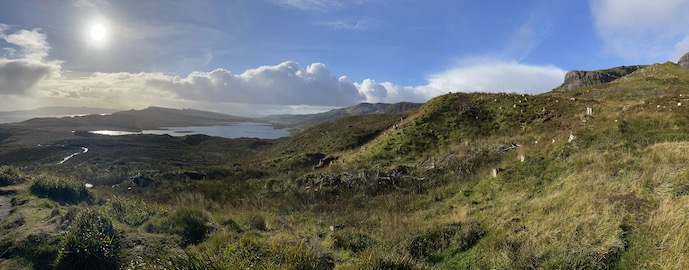 Lake in a valley surrounded by trees and hills