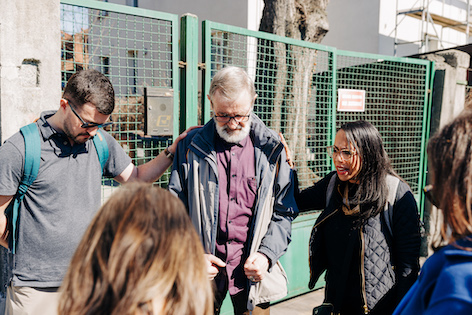 Jack and his team praying with a older Polish pastor.