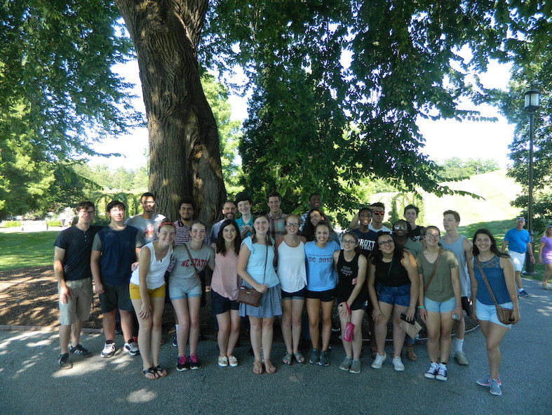 Students pose under a tree in Longwood Gardens
